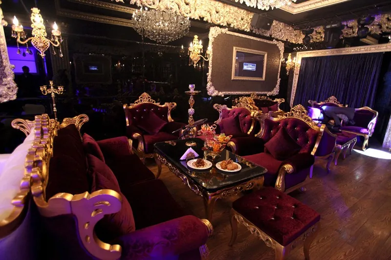 Purple velvet sofas with carved gold frames